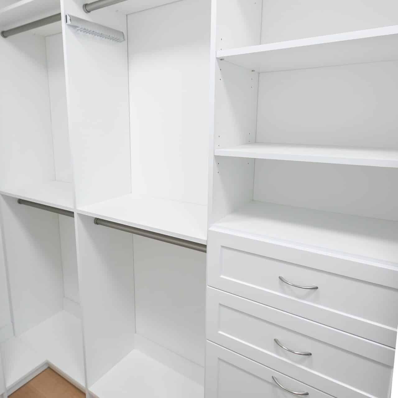 Installed Singh Closets system showing adjustable shelving, drawer bank and matched finishes